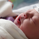 A baby with the non-invasive EEG cap on its head. (Image: University of Oxford)